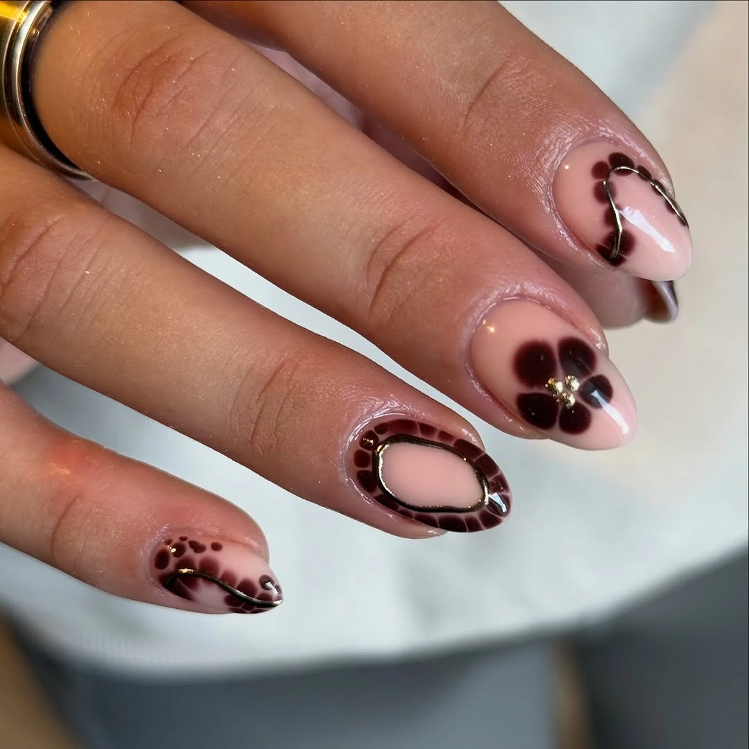chic fall nail trends 2026 Chocolate Florals With Delicate Gold Accents