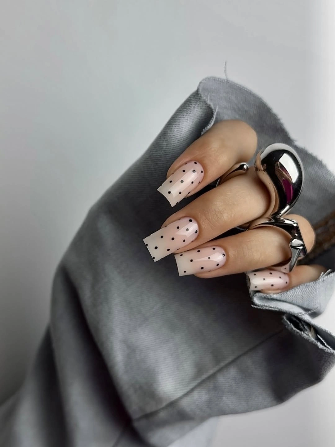 chic fall nails for fair skin tone sheer nude manicure with black dots