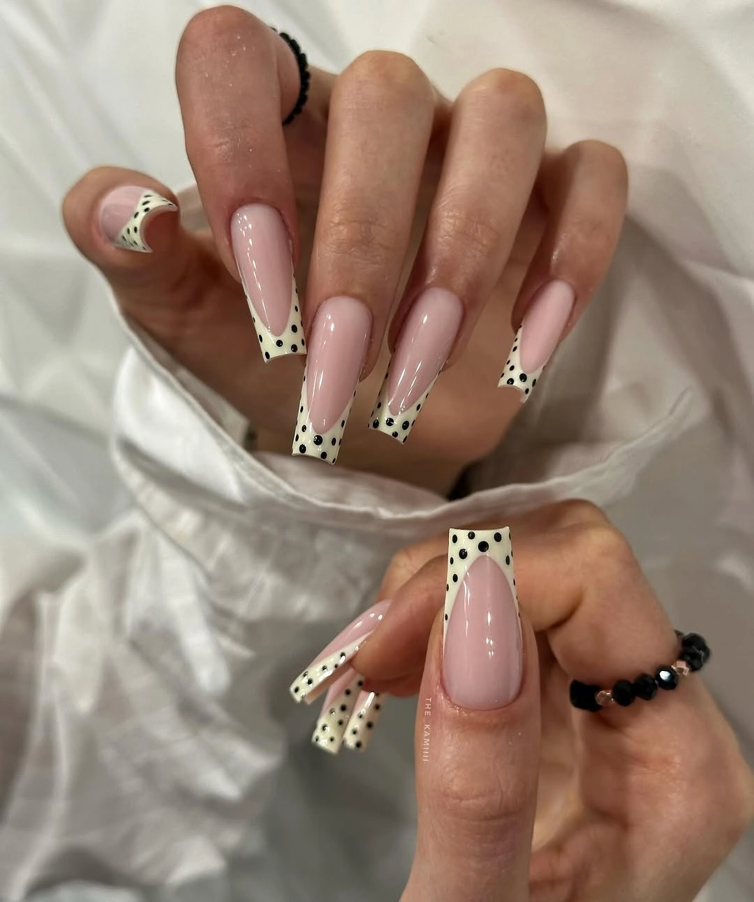 chic fall nails for fair skin tone Pink French Tips With Playful Black Dots