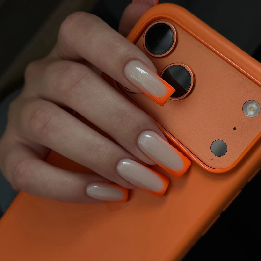 chic fall nails for fair skin tone Milky Nude With Bright Orange Tips