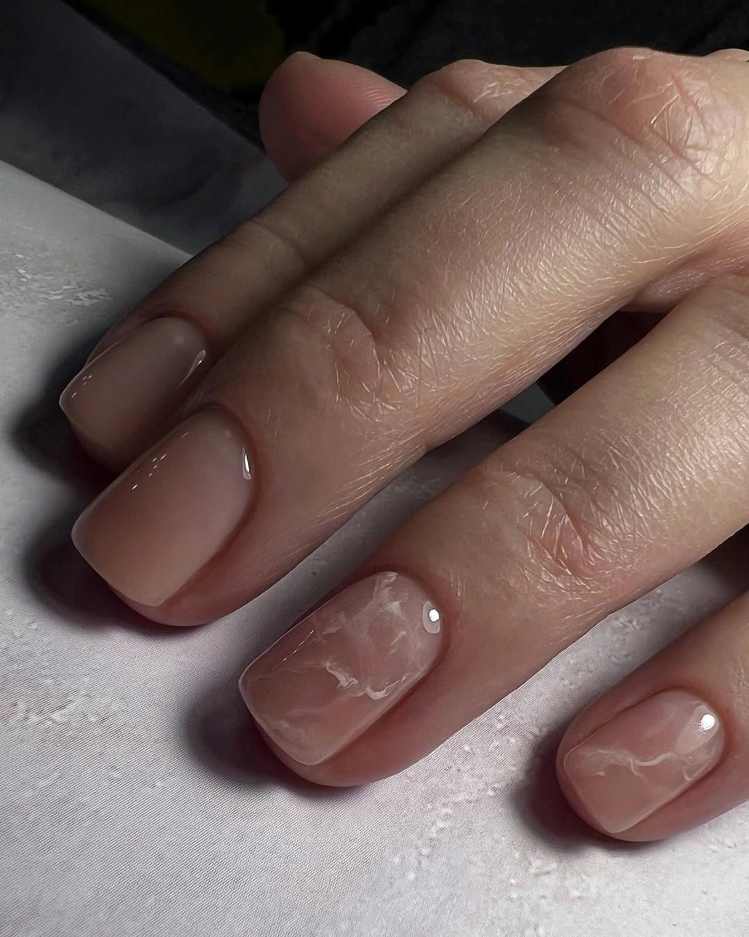 chic nude fall nails 2026 Glossy Nude With Subtle Marble Art