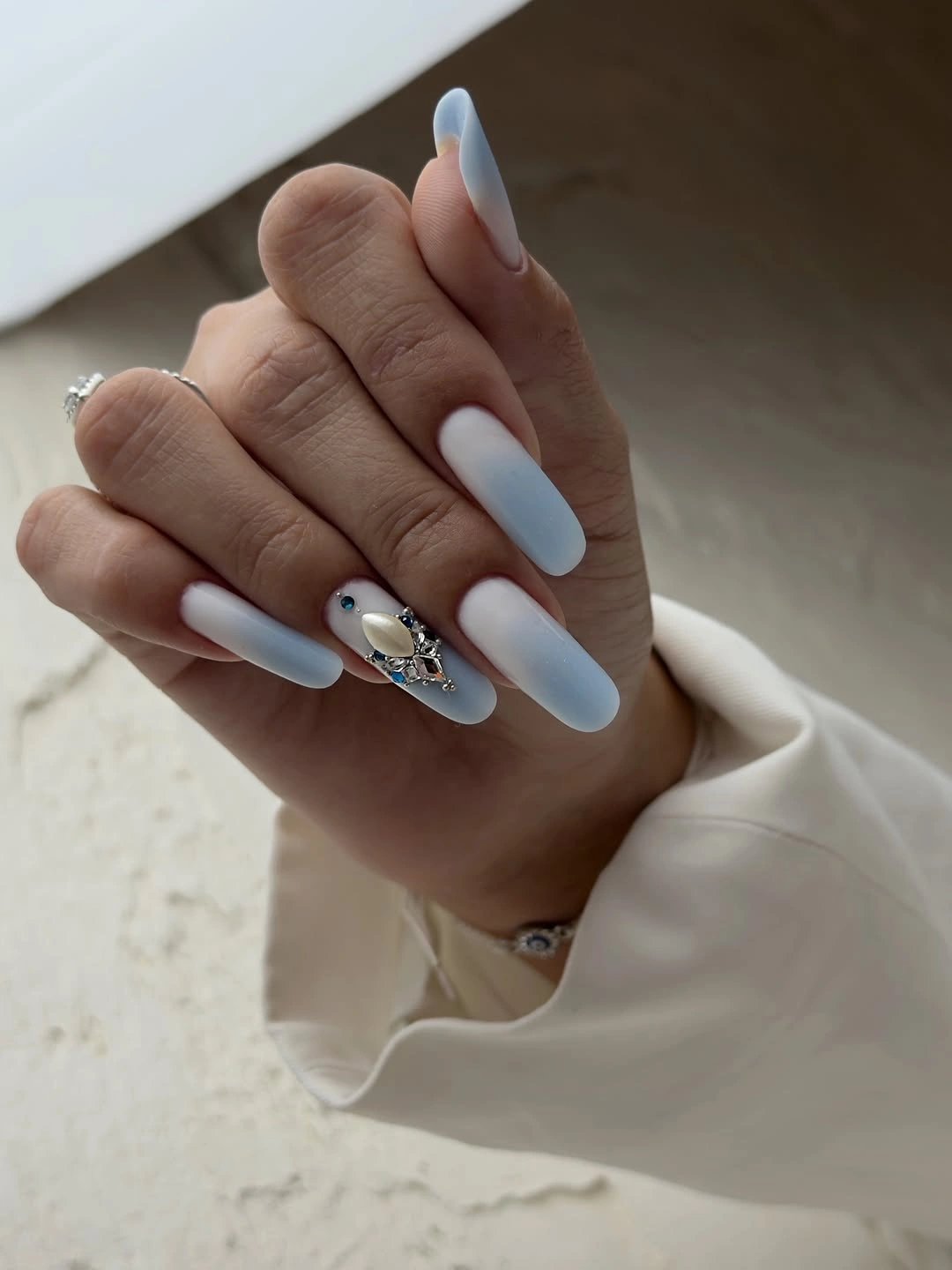classy fall nail designs for office 2026 Soft Blue Ombre With Crystal Accent