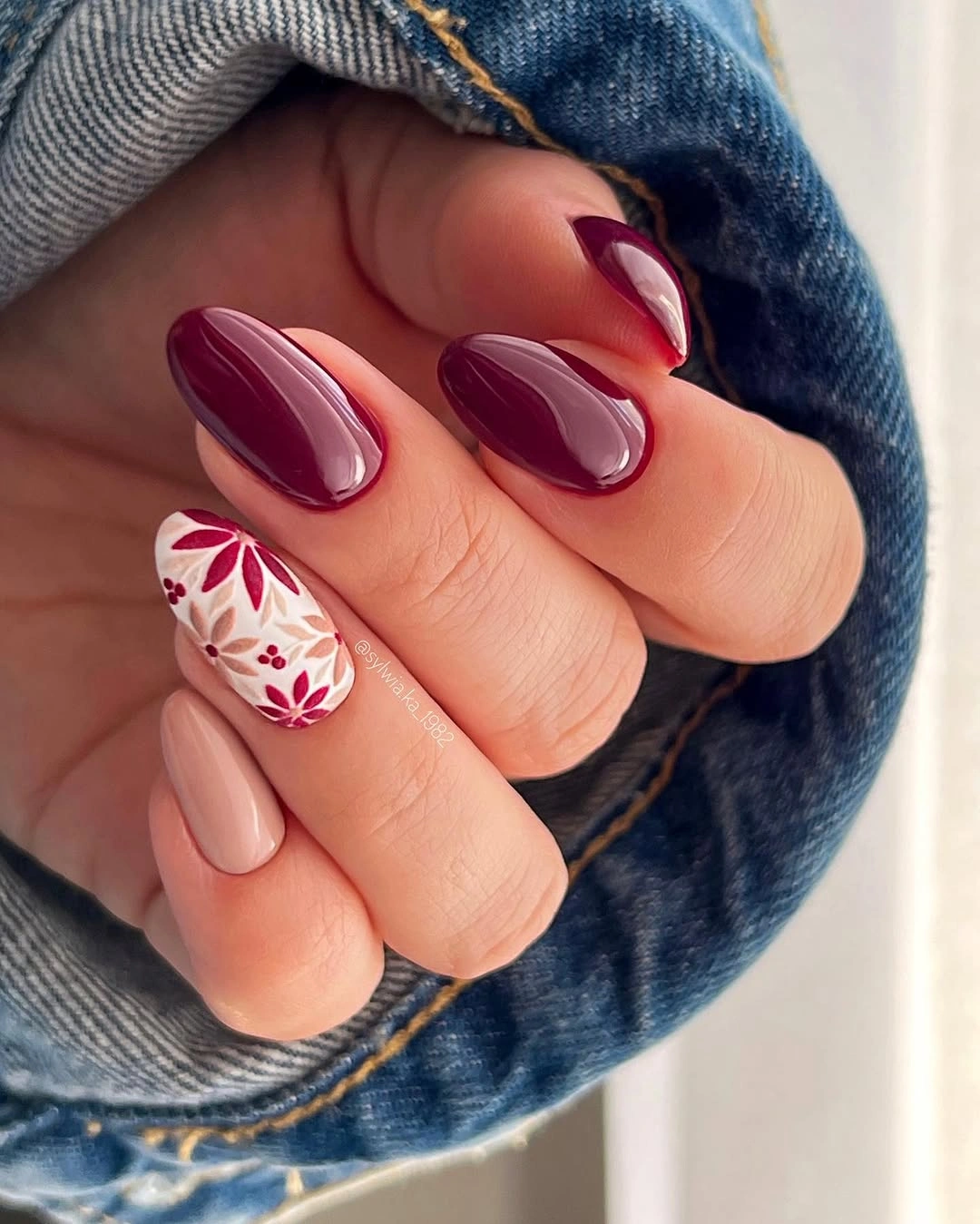 creative fall manicure ideas 2026 Rich Burgundy With Delicate Botanical Accent