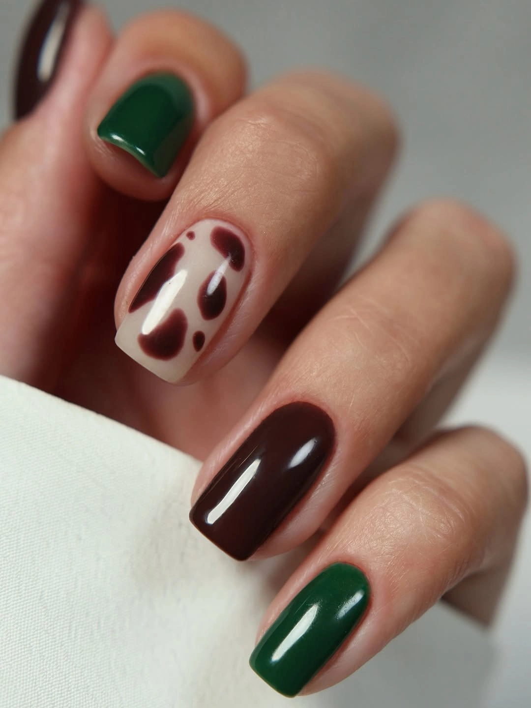 creative fall manicure ideas 2026 Chocolate And Forest Green Cow Print