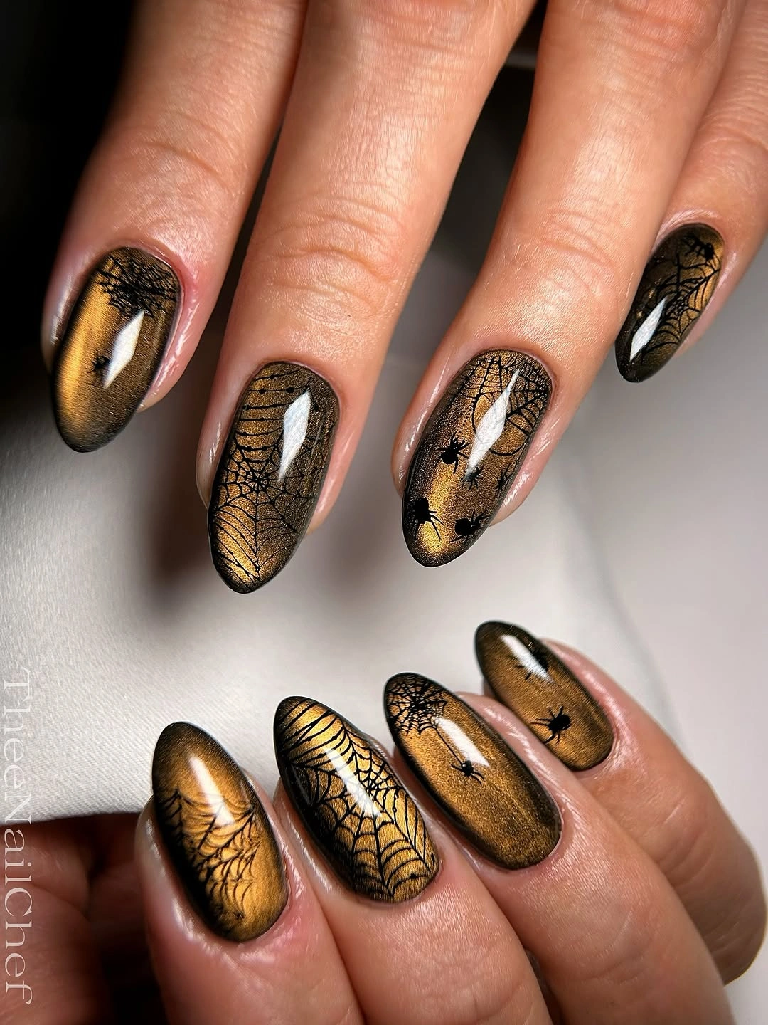 creative fall nail art ideas 2026 gold spiderweb black almond nails