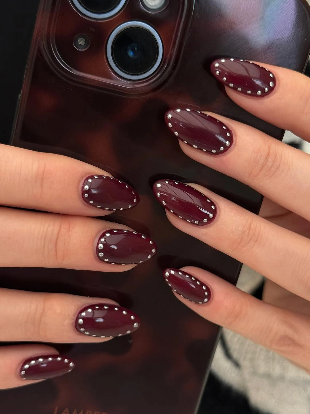creative fall nail art ideas 2026 burgundy almond nails with silver studs