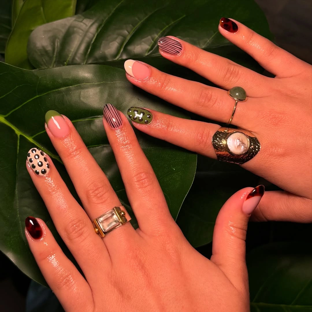 cute fall short almond nails 2026 Mixed Earth Tone Nail Art with Playful Personality