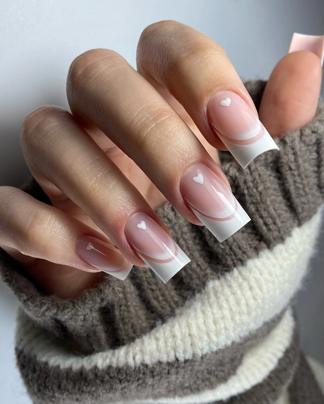 flattering fall nails for olive skin tone 2026 Soft French Tips With Tiny Hearts