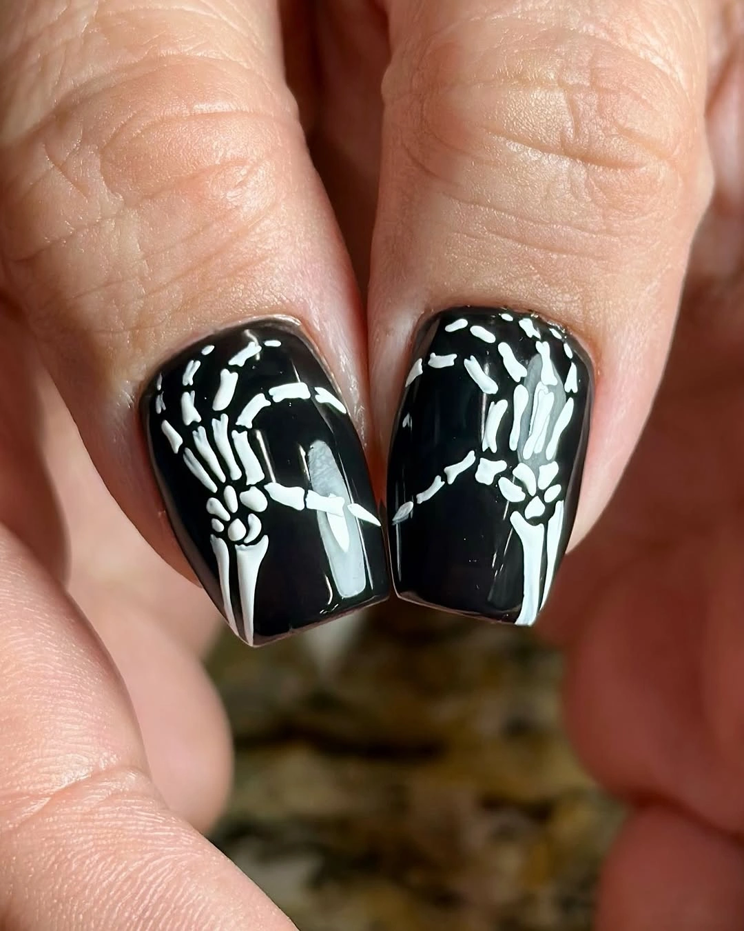 gorgeous fall dark nail shadow ideas 2026 Skeleton Hands on Glossy Black