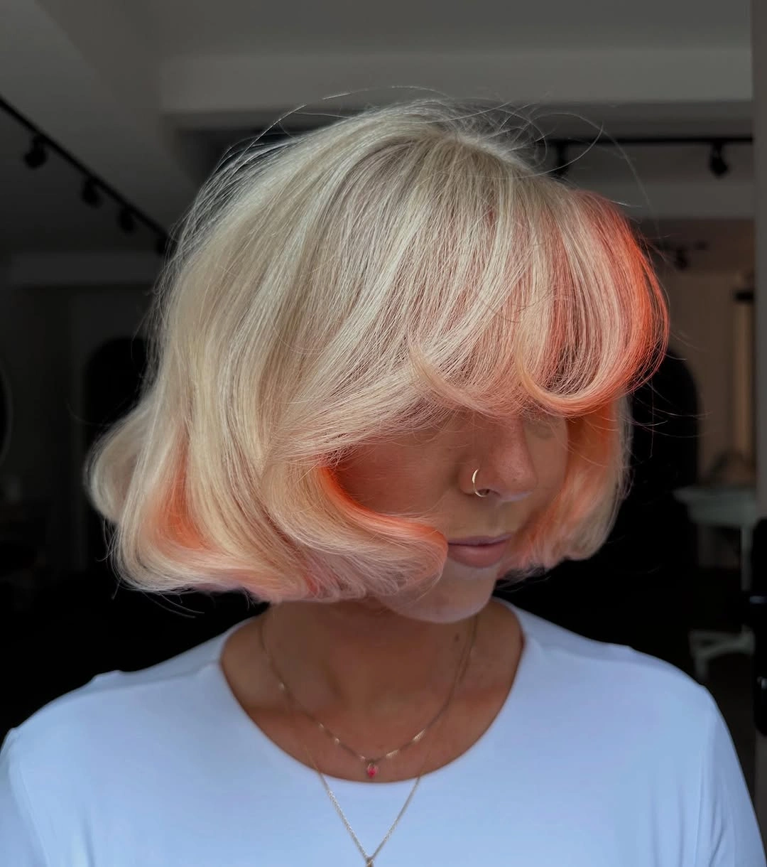 layered bob hair Platinum Blonde bob with sweeping Curtain bangs