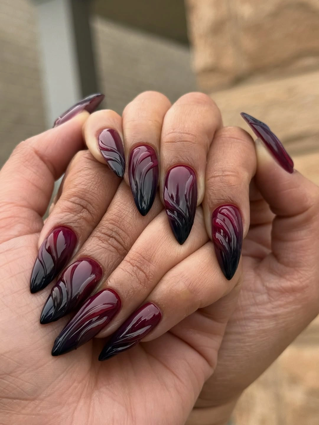 Luxurious maroon fall nails 2026 dark burgundy and black sculptural swirls