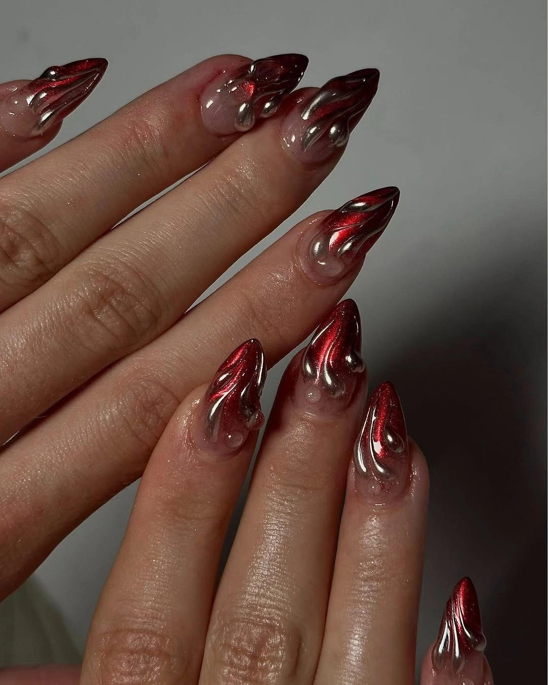Luxurious maroon fall nails 2026 red chrome liquid metal almond nails
