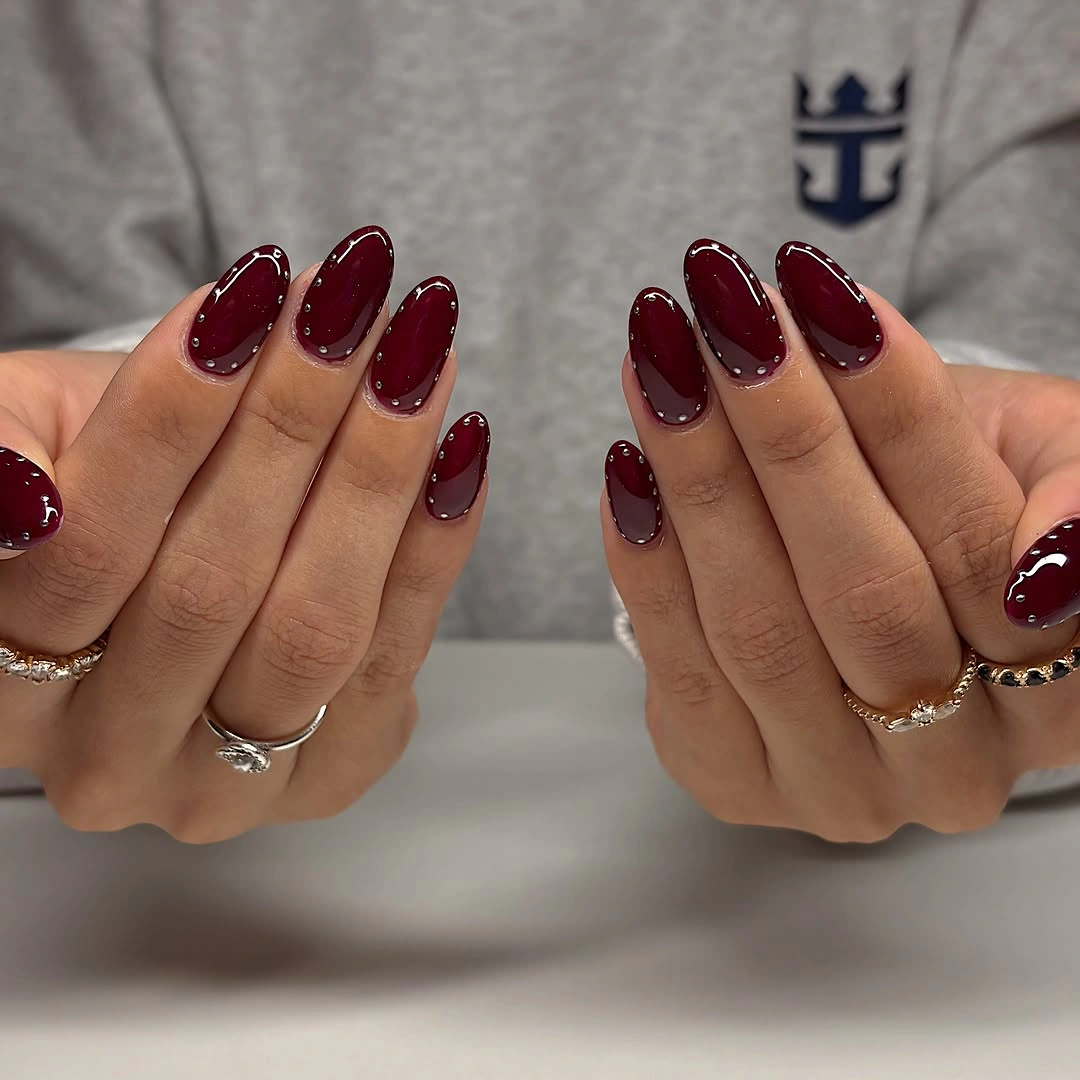 luxurious maroon fall nails 2026 Glossy Burgundy Almond With Micro Studs