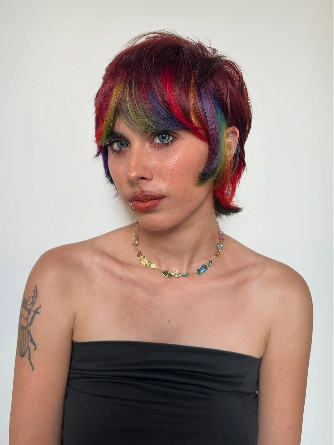 modern october haircut ideas 2026 Short Burgundy Pixie With Rainbow Color Accents