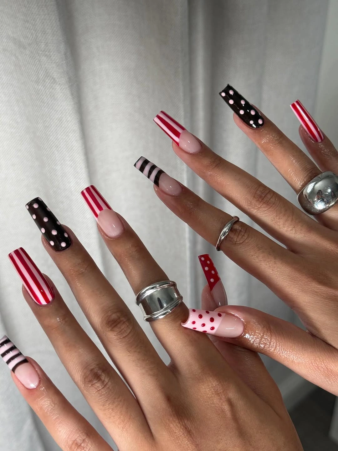 playful polka dot fall nails 2026 Red Black and Pink Mixed Polka Dot French Nails