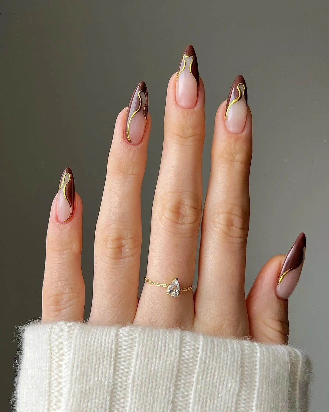 rich brown fall nails 2026 Dark Brown French Almond Nails With Gold Waves