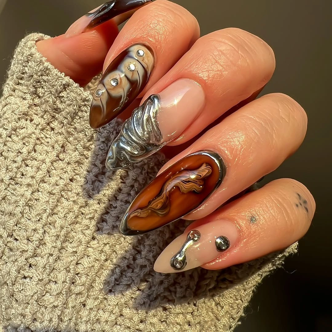 rich brown fall nails 2026 Modern Marble With Metallic Chrome Details