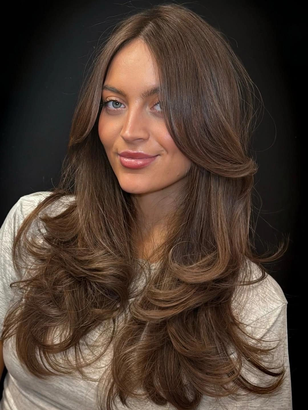 rich october hair colour ideas 2026 Glossy Mocha Brown With Feathered Volume