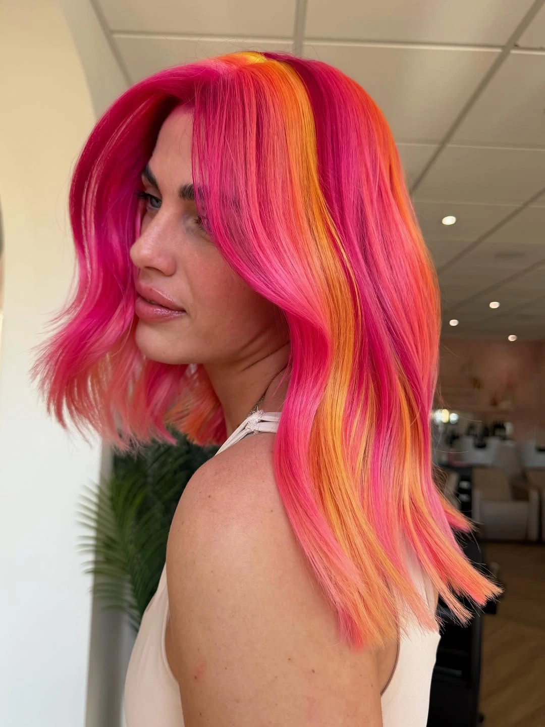 rich october hair colour ideas 2026 Hot Pink and Tangerine Color Melt