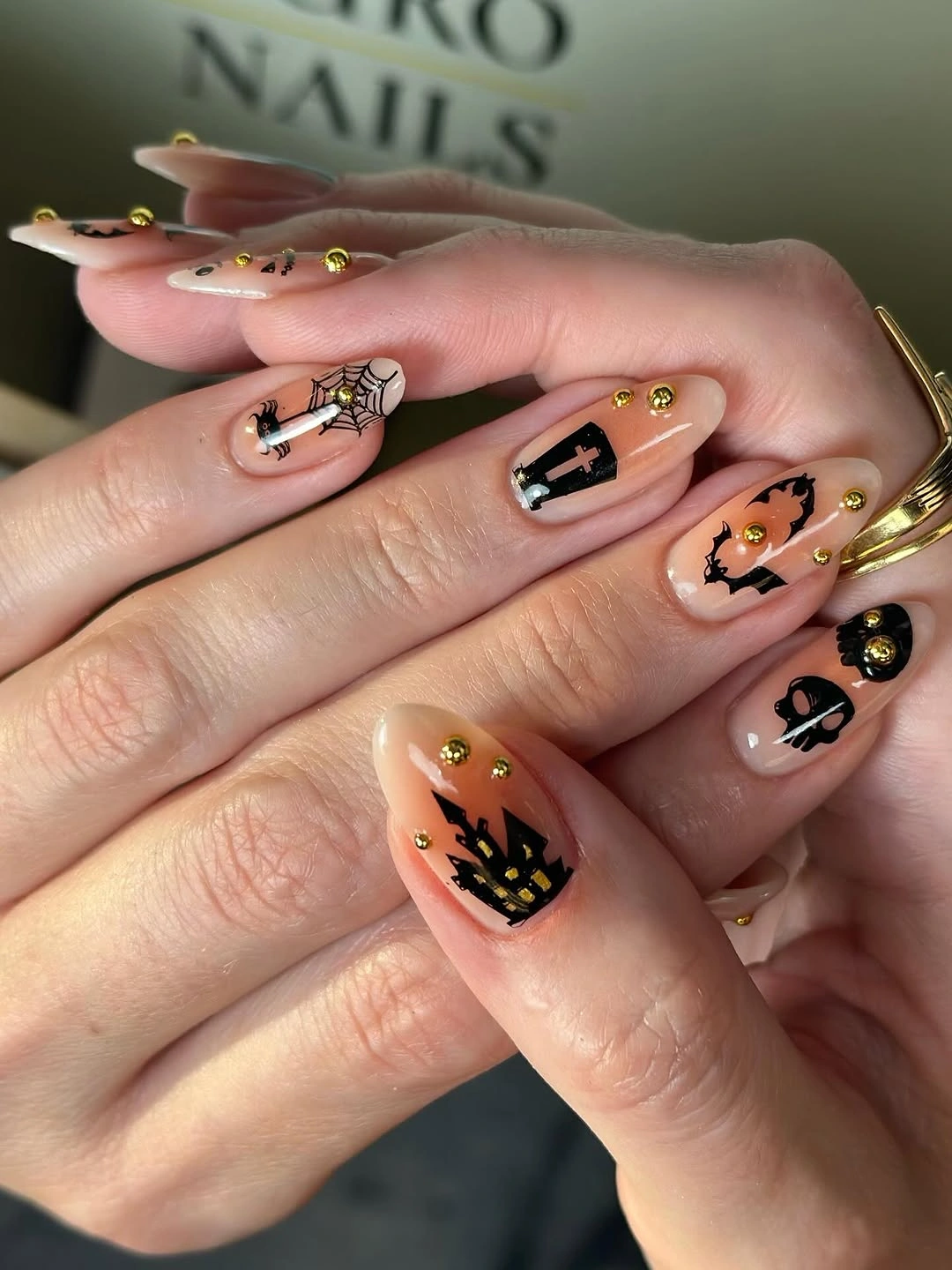 spooky halloween nail art 2026 Minimal Black Halloween Symbols on a Nude Base
