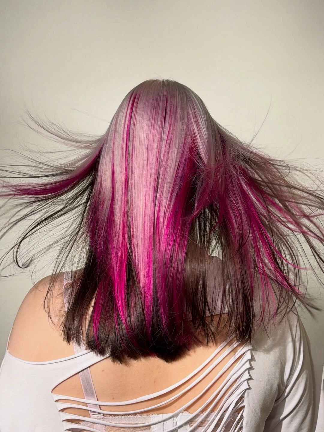 stunning september hair colour trends 2026 Brunette With Electric Magenta Ribbons