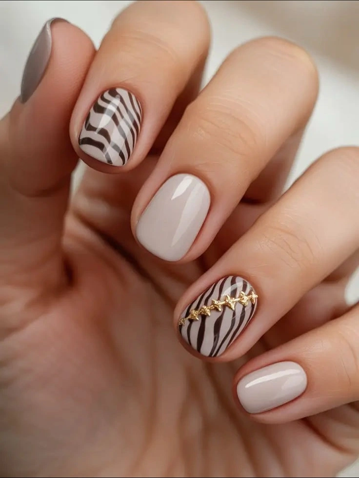 stylish fall gel nails ideas 2026 Short Cream Nails With Zebra Waves And Gold