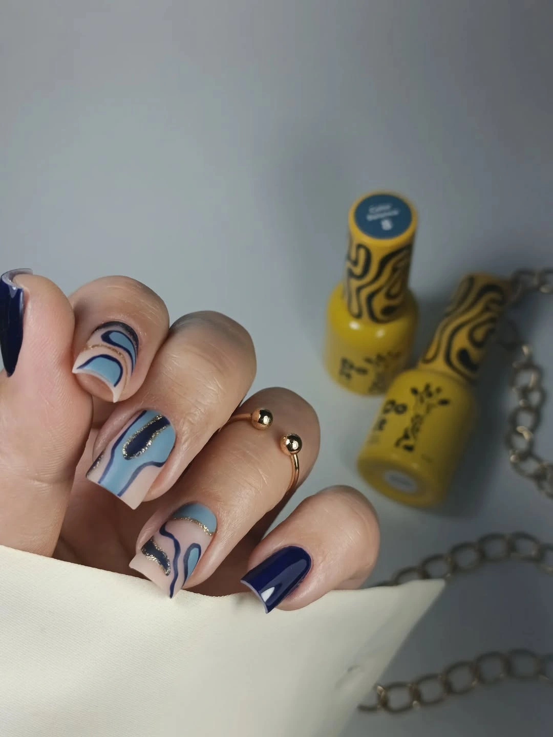 stylish fall gel nails ideas 2026 Moody Blue Abstract Nails With Gold Accents