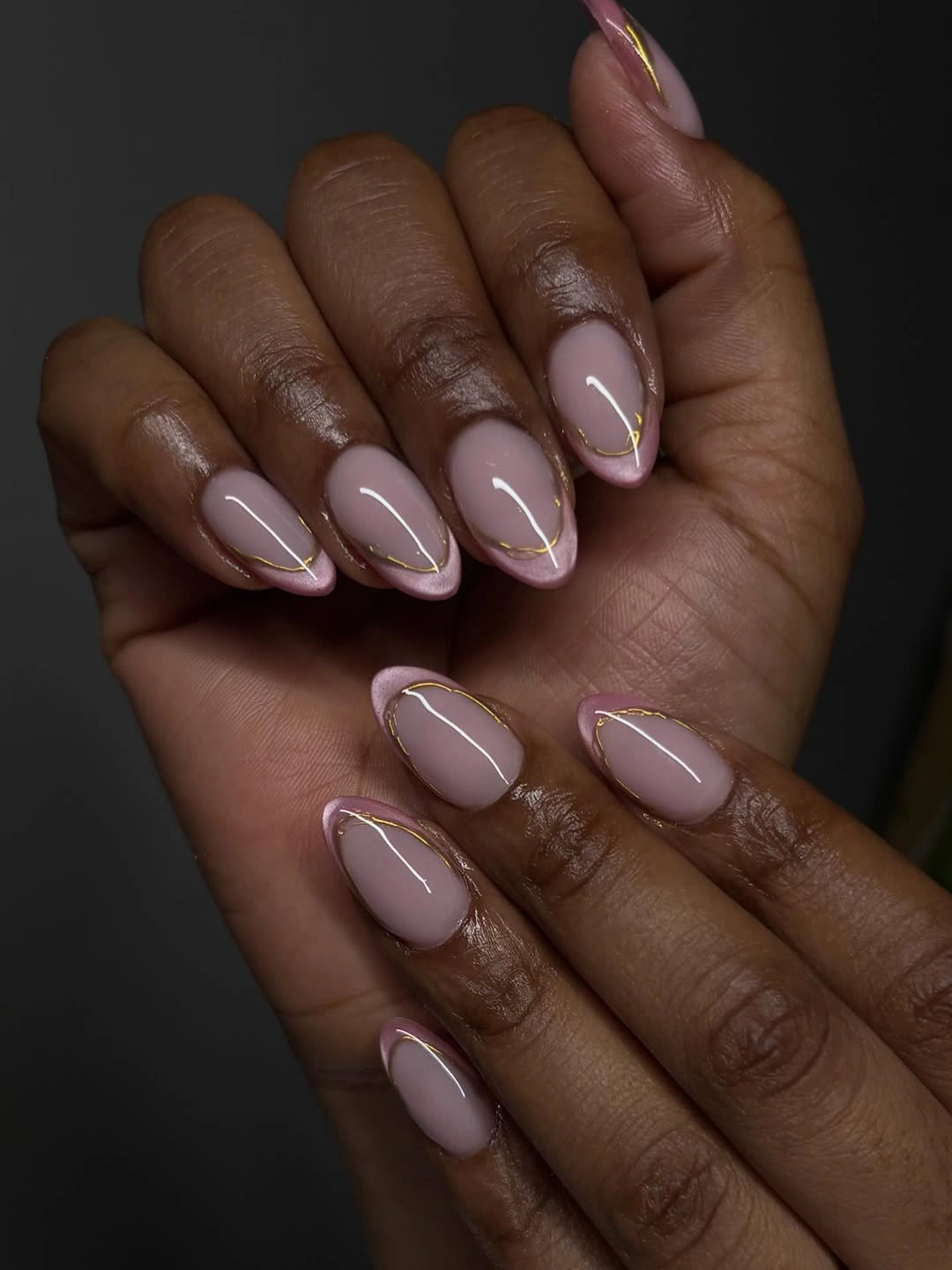 stylish fall nails for dark skin 2026 Soft Pink Almond With Golden Contours