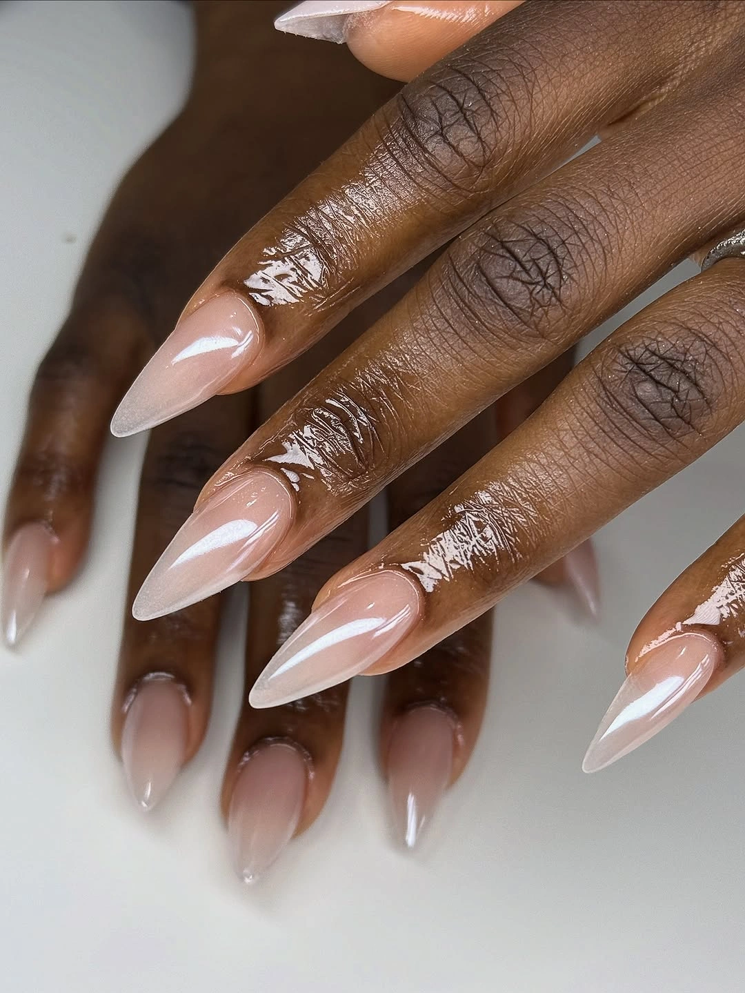stylish fall nails for dark skin 2026 Milky Ombre Almond Finish