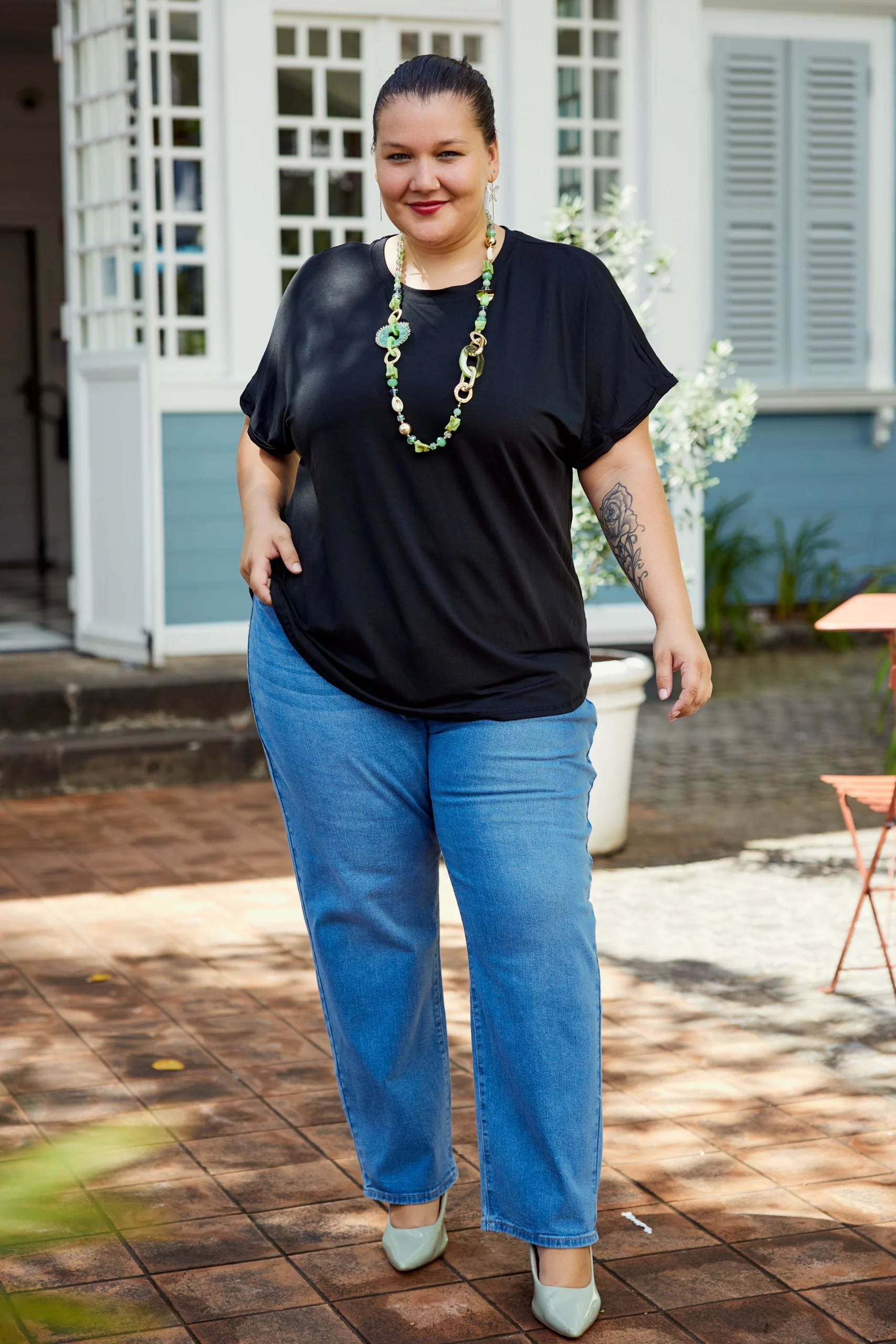 Casual Blue Jeans and Black Top Elevated by Green Accessories — Winter Outfits for Curvy Women
