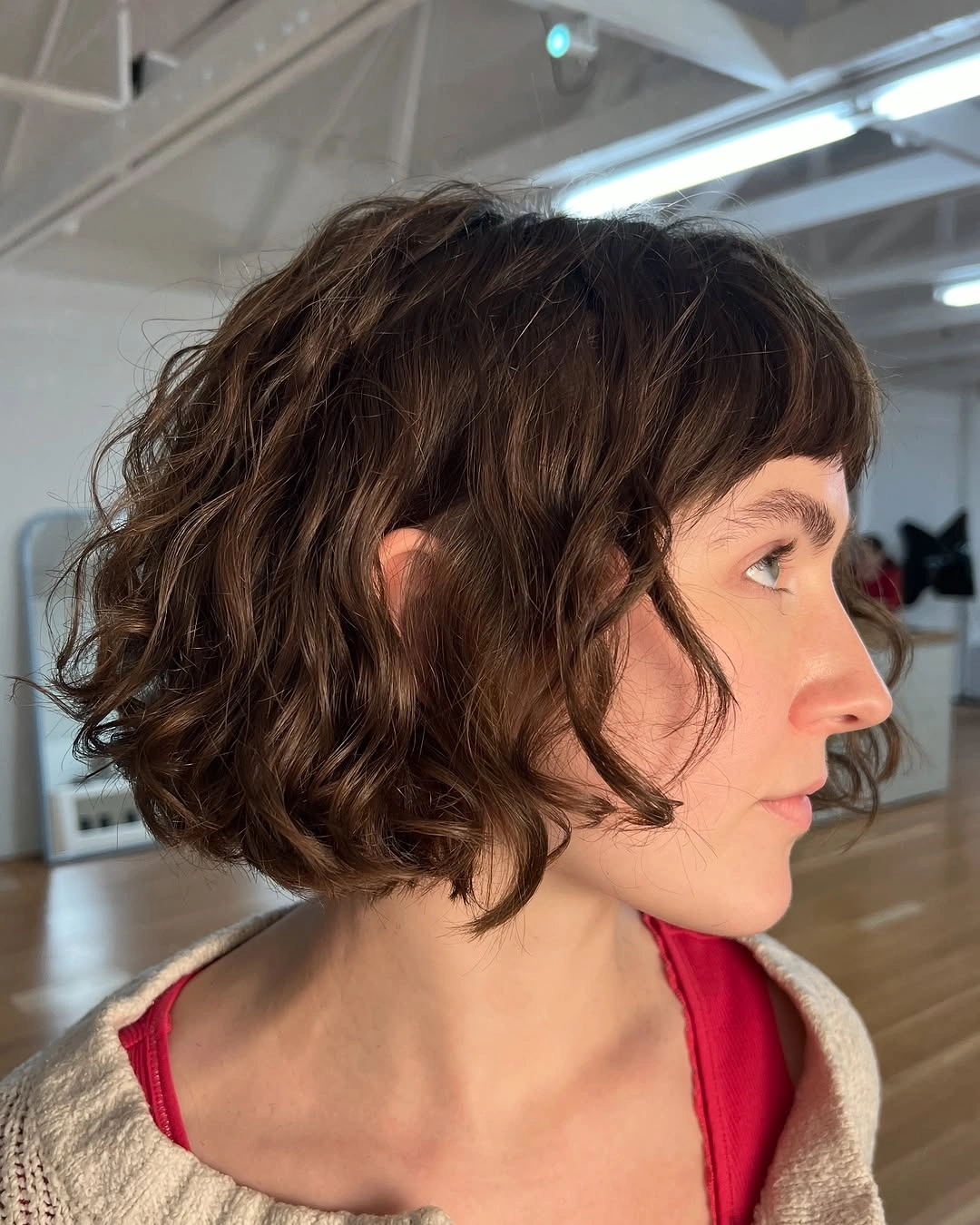 chic curly bob hair Dark Curly Bob With Graphic Bangs