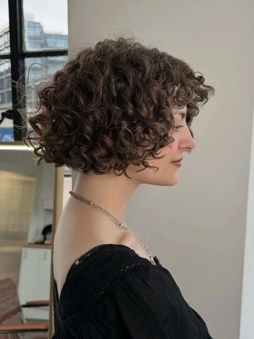 chic curly bob hair Defined Brown Curls With a Refined Silhouette