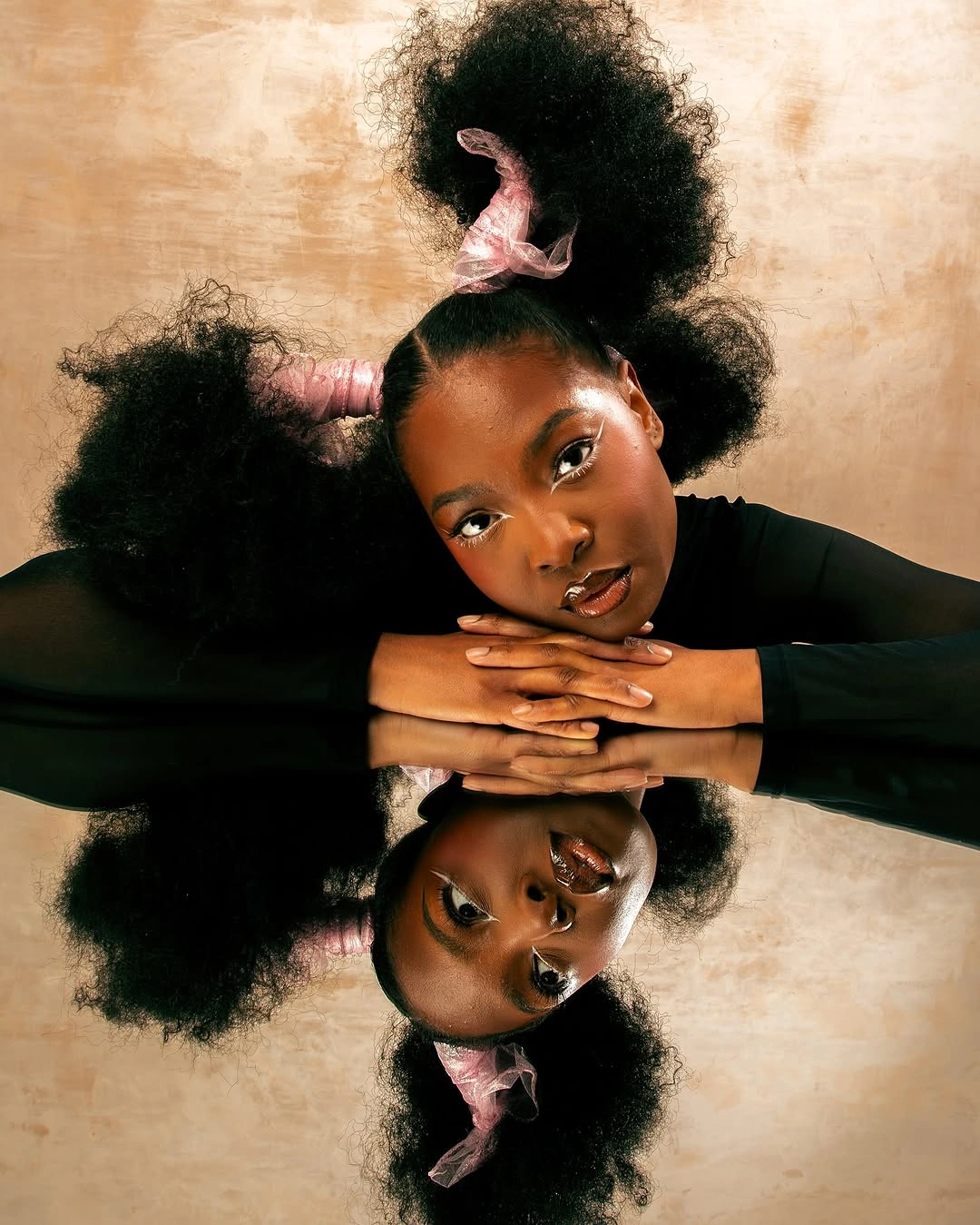 chic hairstyle ideas for black women 2027 Soft Afro Puffs With Pink Ribbons
