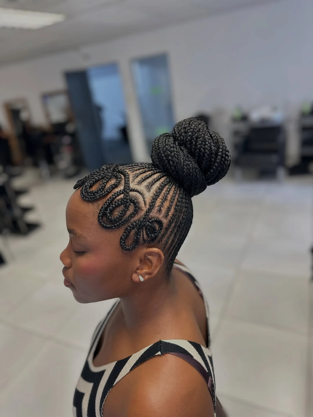 chic hairstyle ideas for black women 2027 Intricate Braided Bun With Curved Details