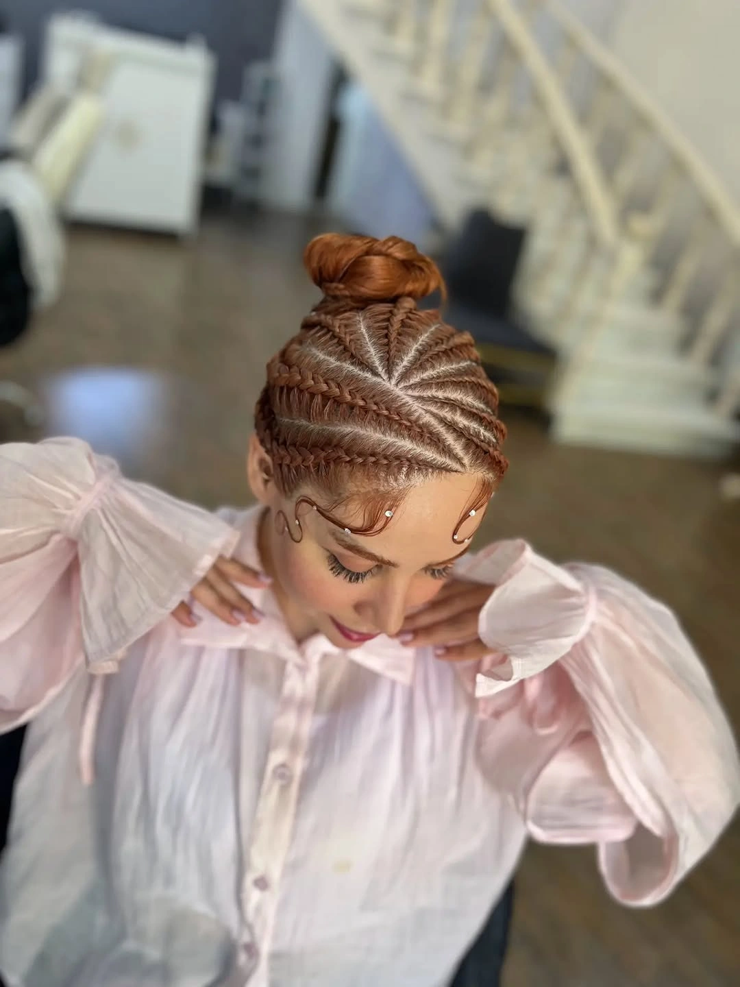 cute braid hairstyle for women Intricate Braided Bun With a Soft Pink Finish