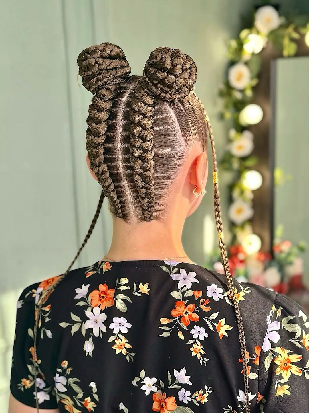 cute braid hairstyle for women Double Braided Buns With Floral Contrast