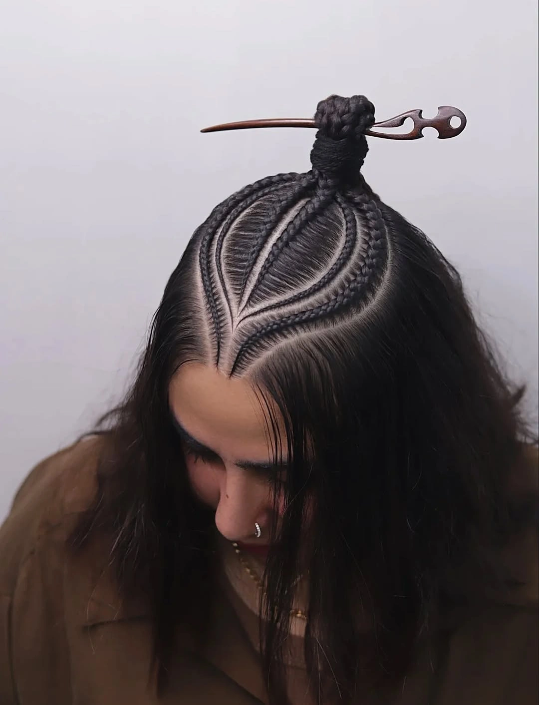 cute braid hairstyle for women Sculptural Black Braids With a Top Knot