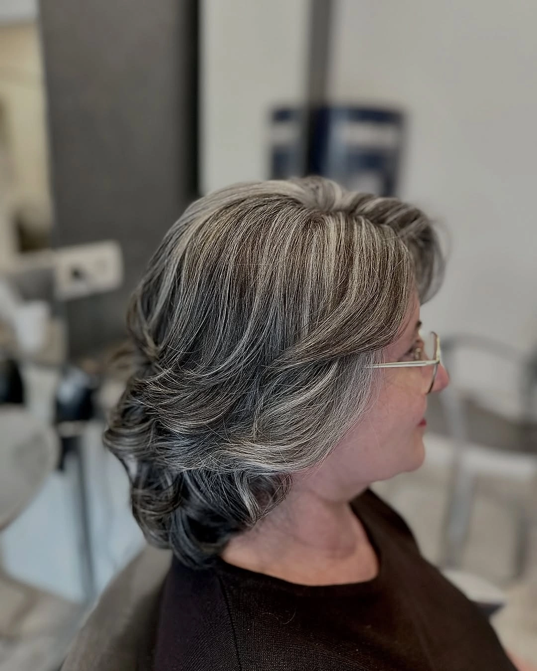 elegant and trendy haircuts for women over 40 2027 - Silver Swept-Back Elegance
