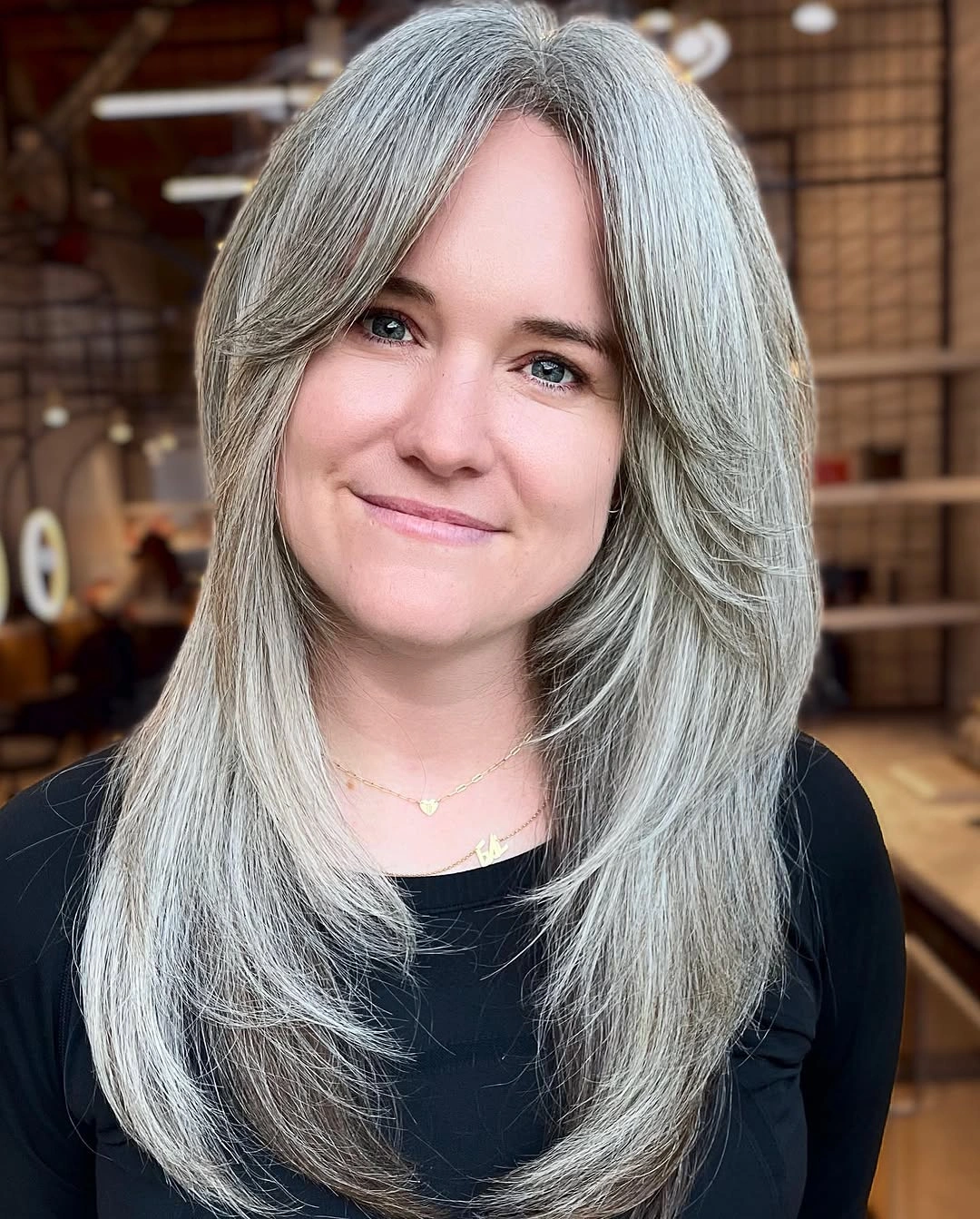 elegant and trendy haircuts for women over 40 2027 - Long Silver Layers With Curtain Bangs