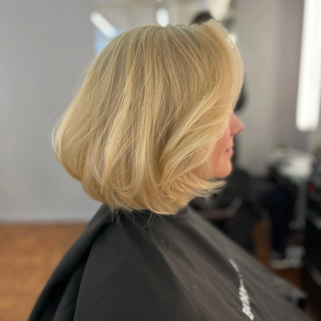 elegant and trendy haircuts for women over 40 2027 Soft Blonde Bob with Feathered Ends