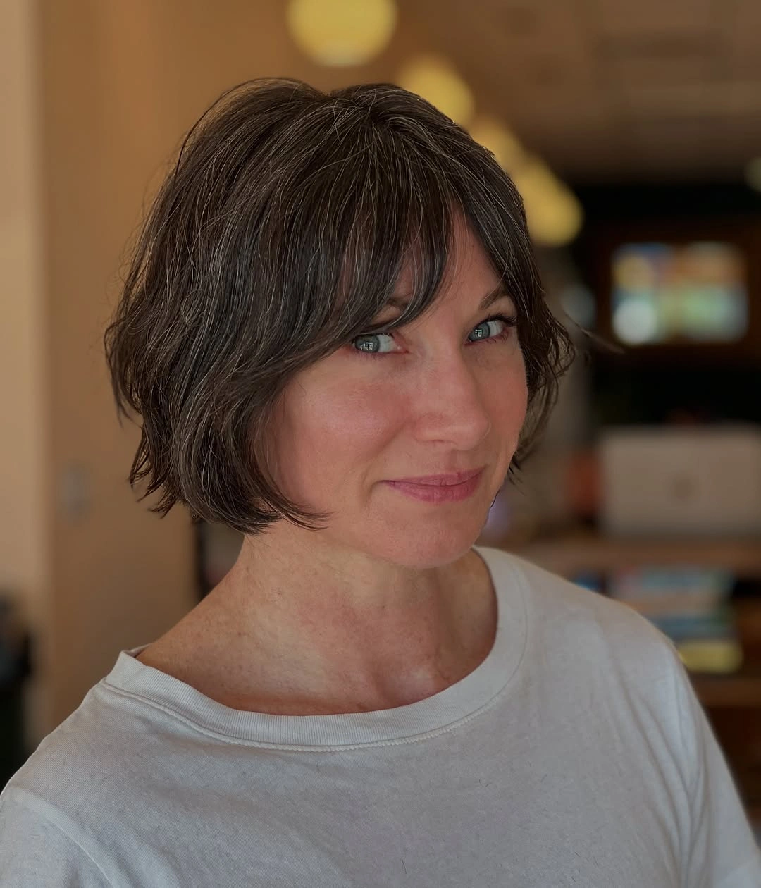 elegant and trendy haircuts for women over 40 2027 Textured Bob with Curtain Bangs