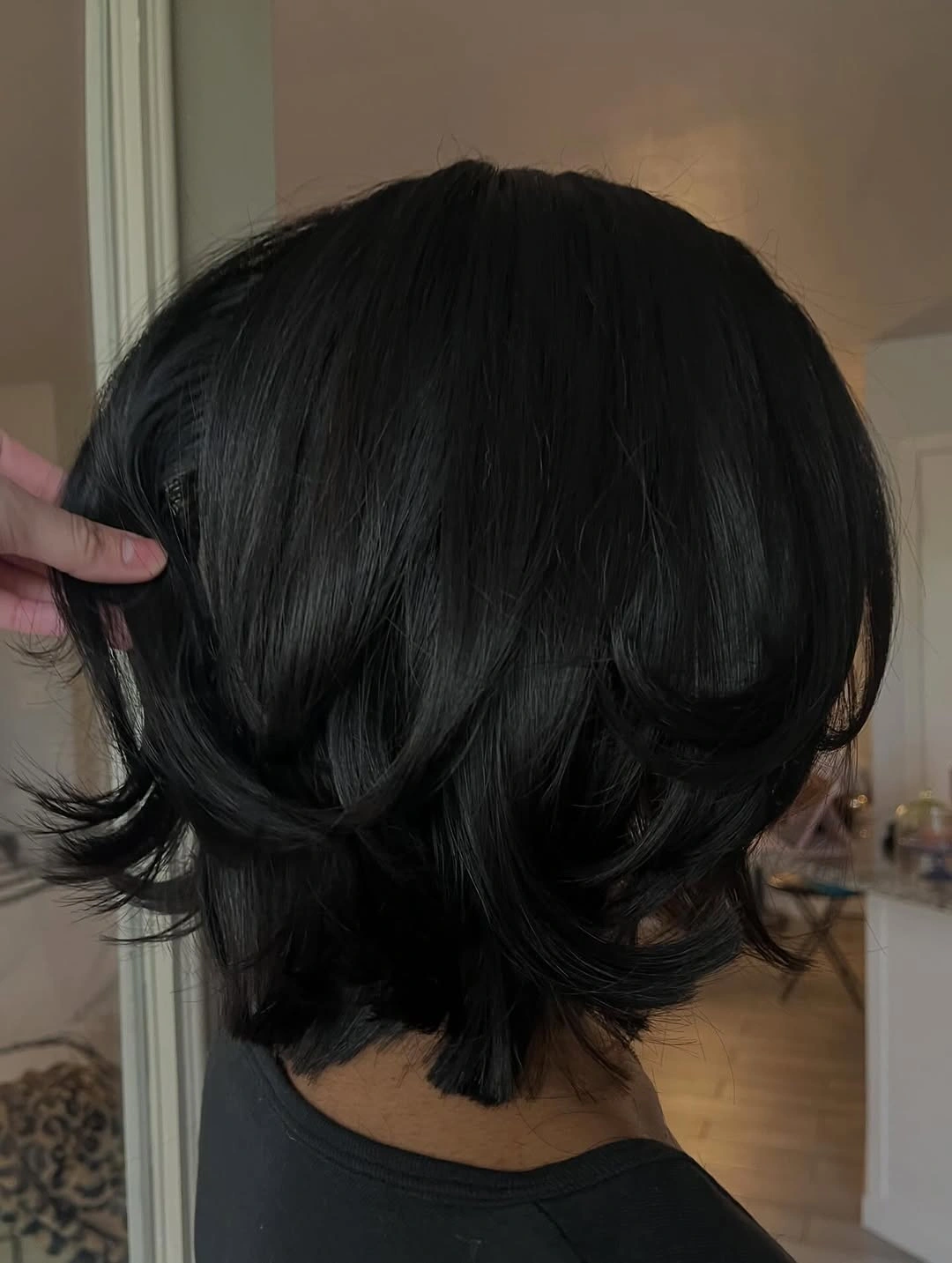 flattering winter haircuts for plus size women - Black Layered Bob With Flicked Ends