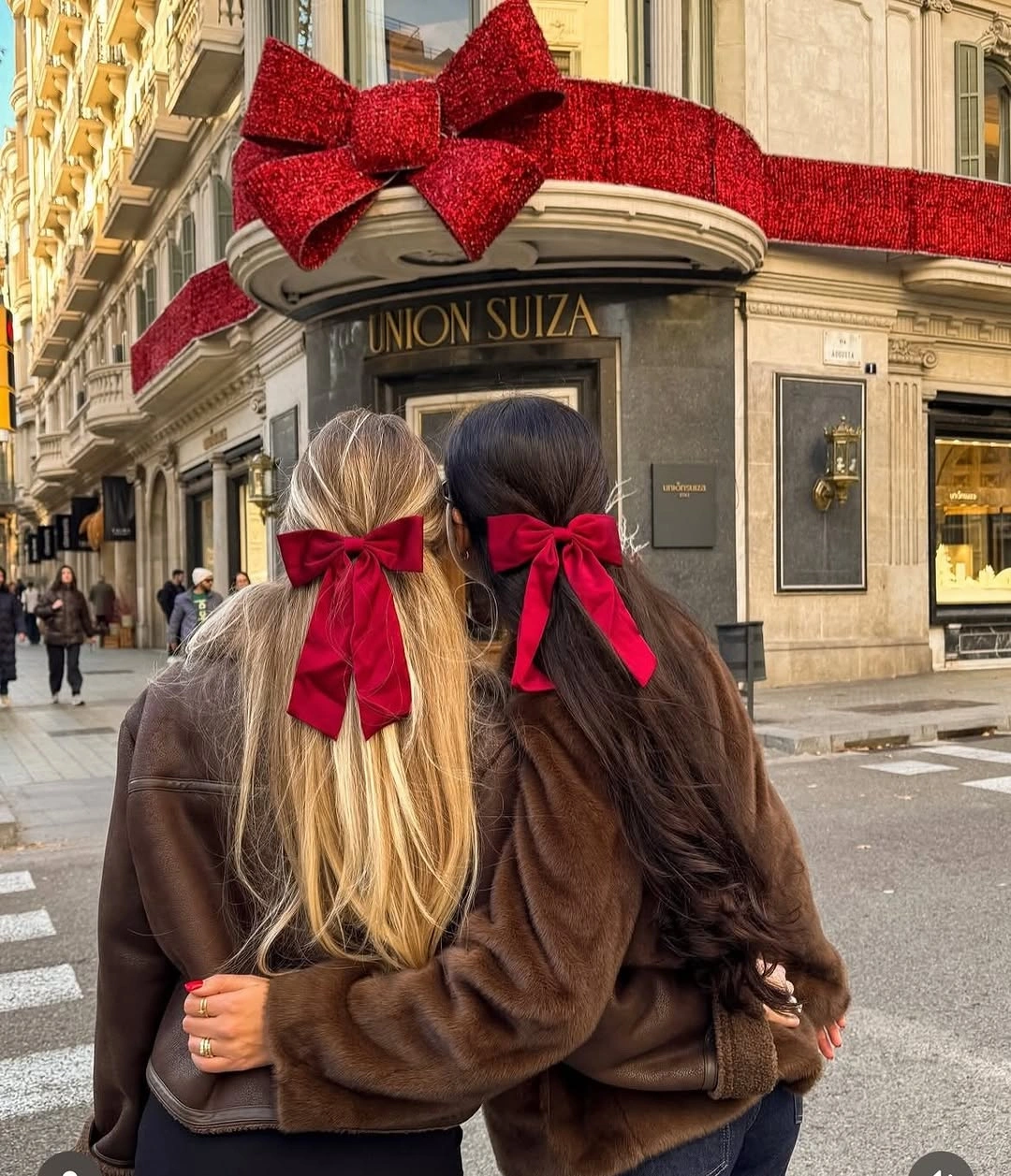 glamorous christmas hairstyles 2026 - Long blonde and brunette hair with statement Christmas bows