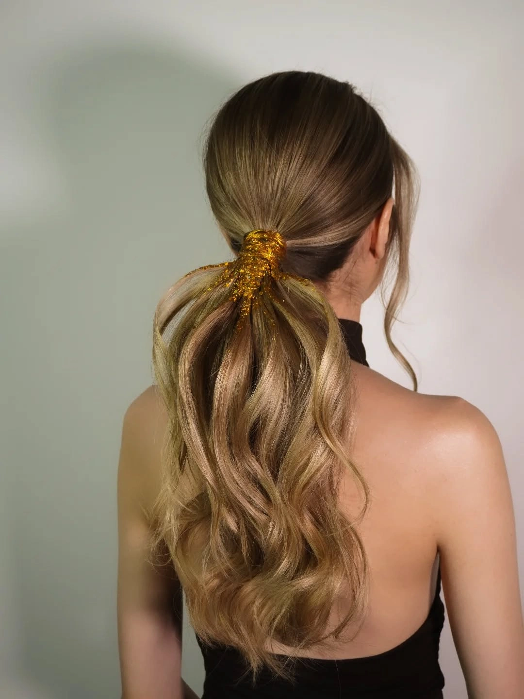 glamorous christmas hairstyles 2026 - Golden Glitter Low Ponytail