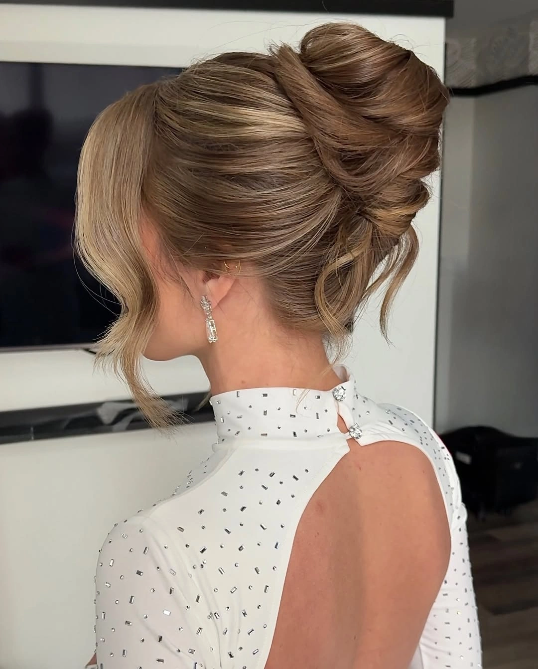 glamorous christmas hairstyles 2026 - Elegant twisted updo with face-framing blonde pieces