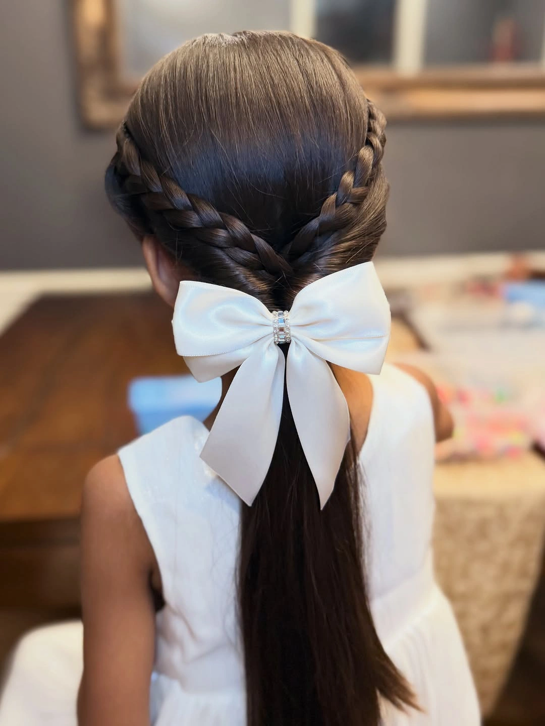glamorous christmas hairstyles 2026 - Braided crown with a white bow