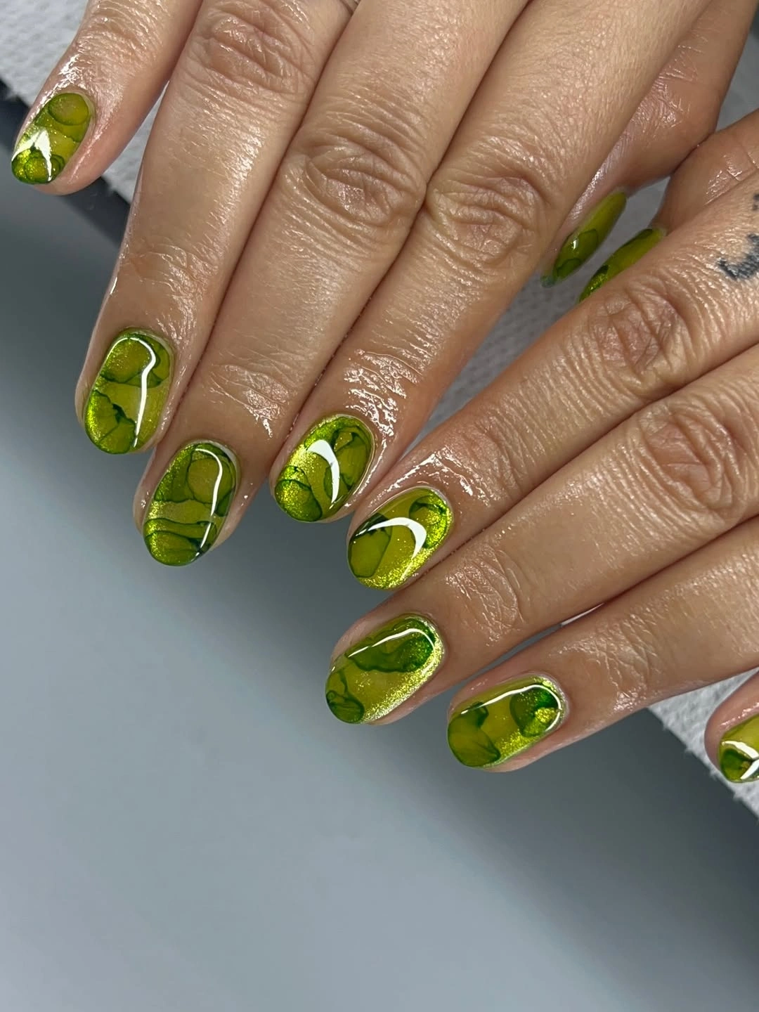 gorgeous short nails 2027 Glossy Green Marble Art