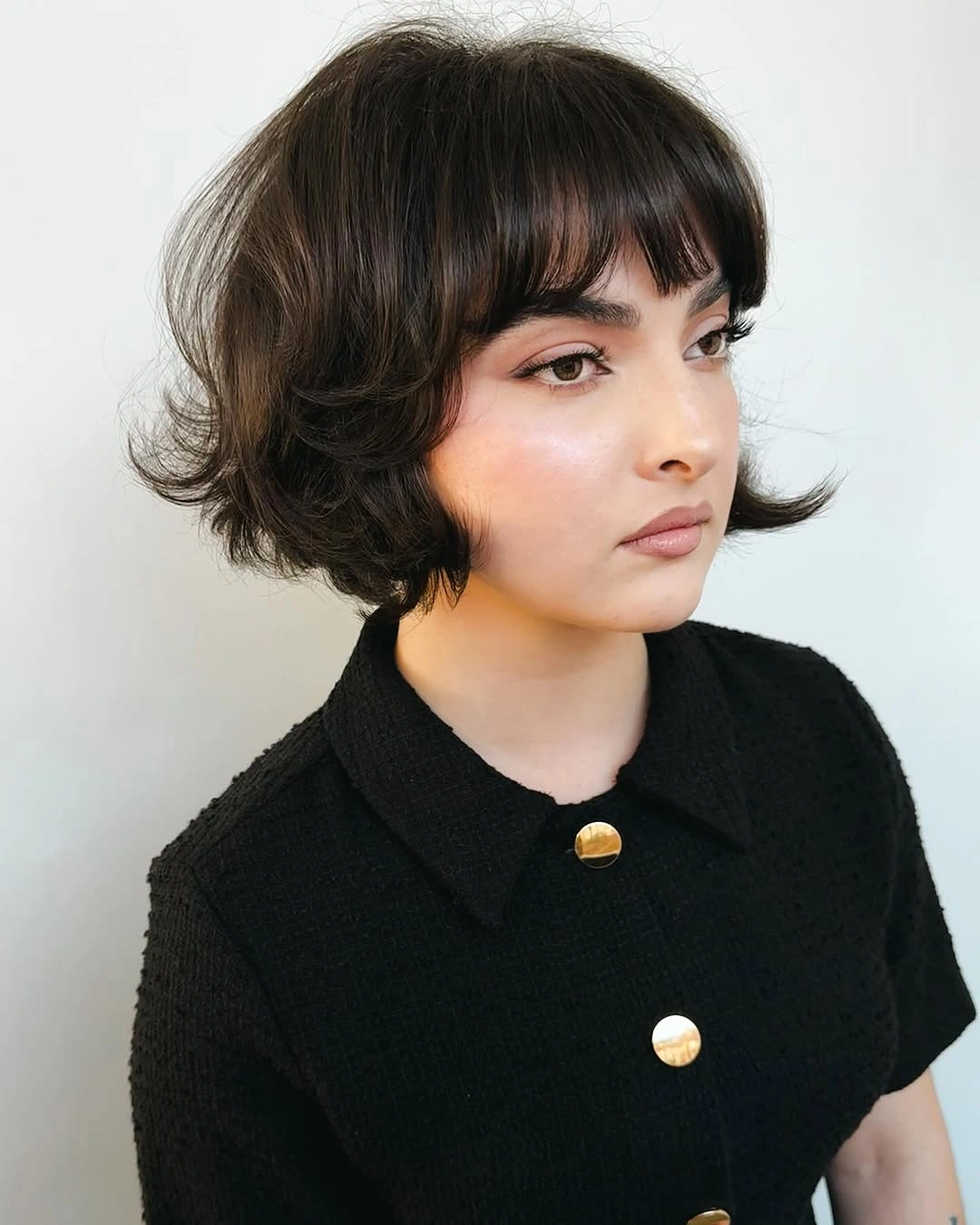 modern bobbed haircut Rounded Brunette Bob With Curved Bangs