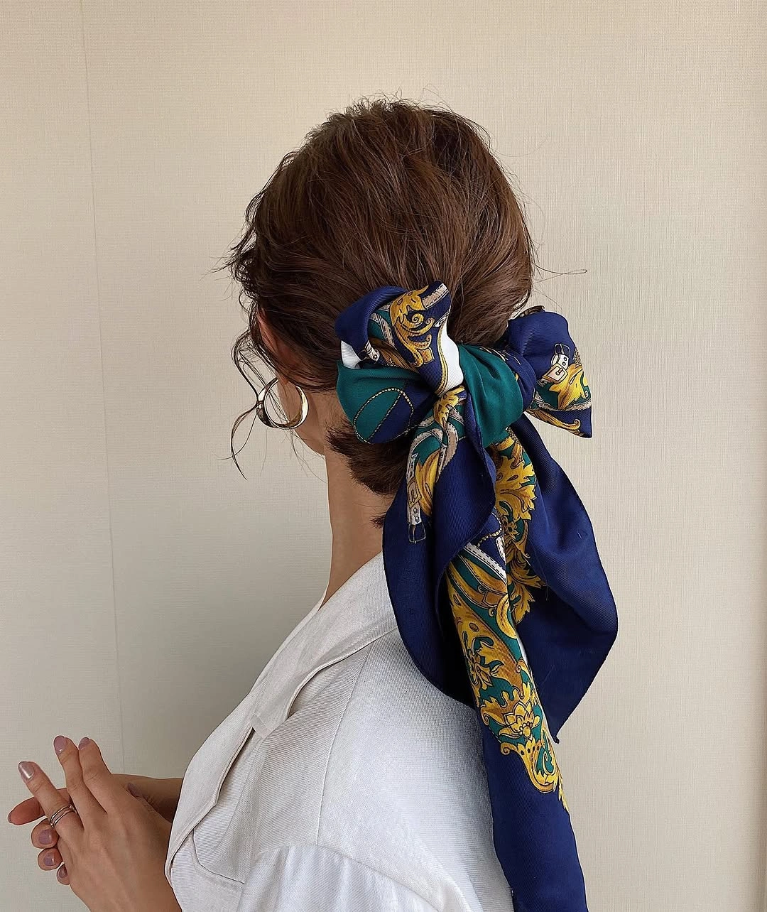 modern scarf hairstyle Oversized Bow With a Low Bun