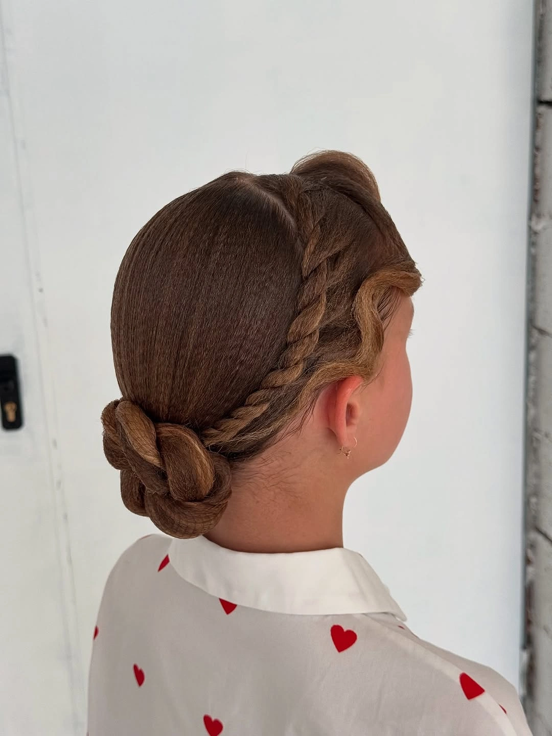 sstylish sports hairstyle Low Bun With a Side Braid